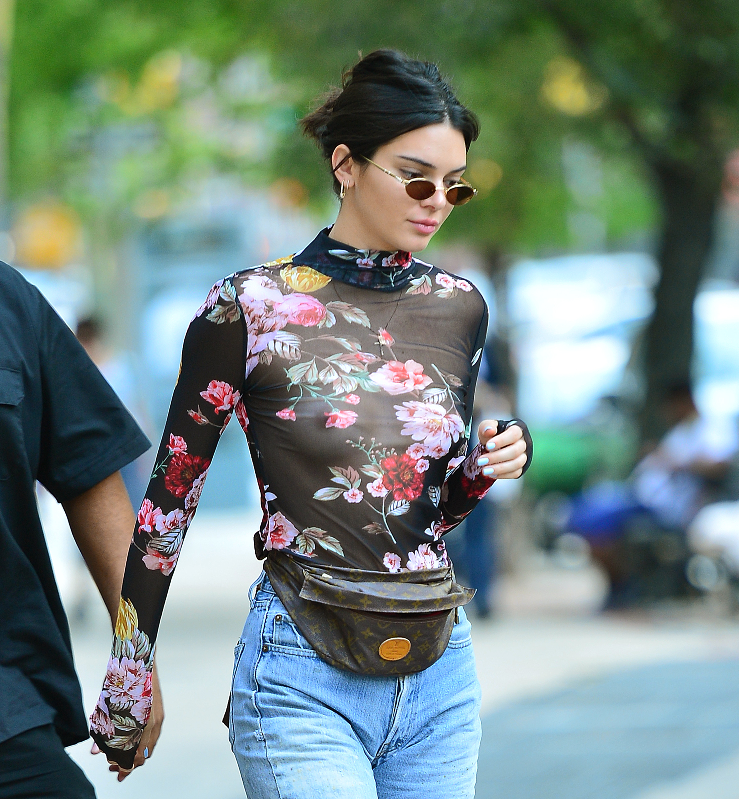 Kendall Jenner looks striking in a see through floral mesh top and daisy du...